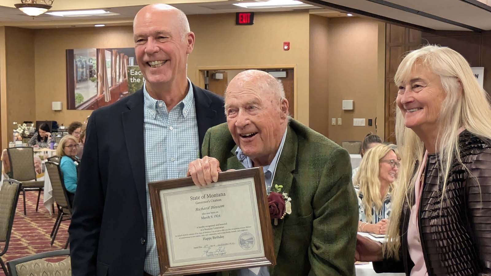 Montana Gov. Greg Gianforte, left, and first lady Susan Gianforte, right, award a plaque to Richard Blossom of Great Falls.