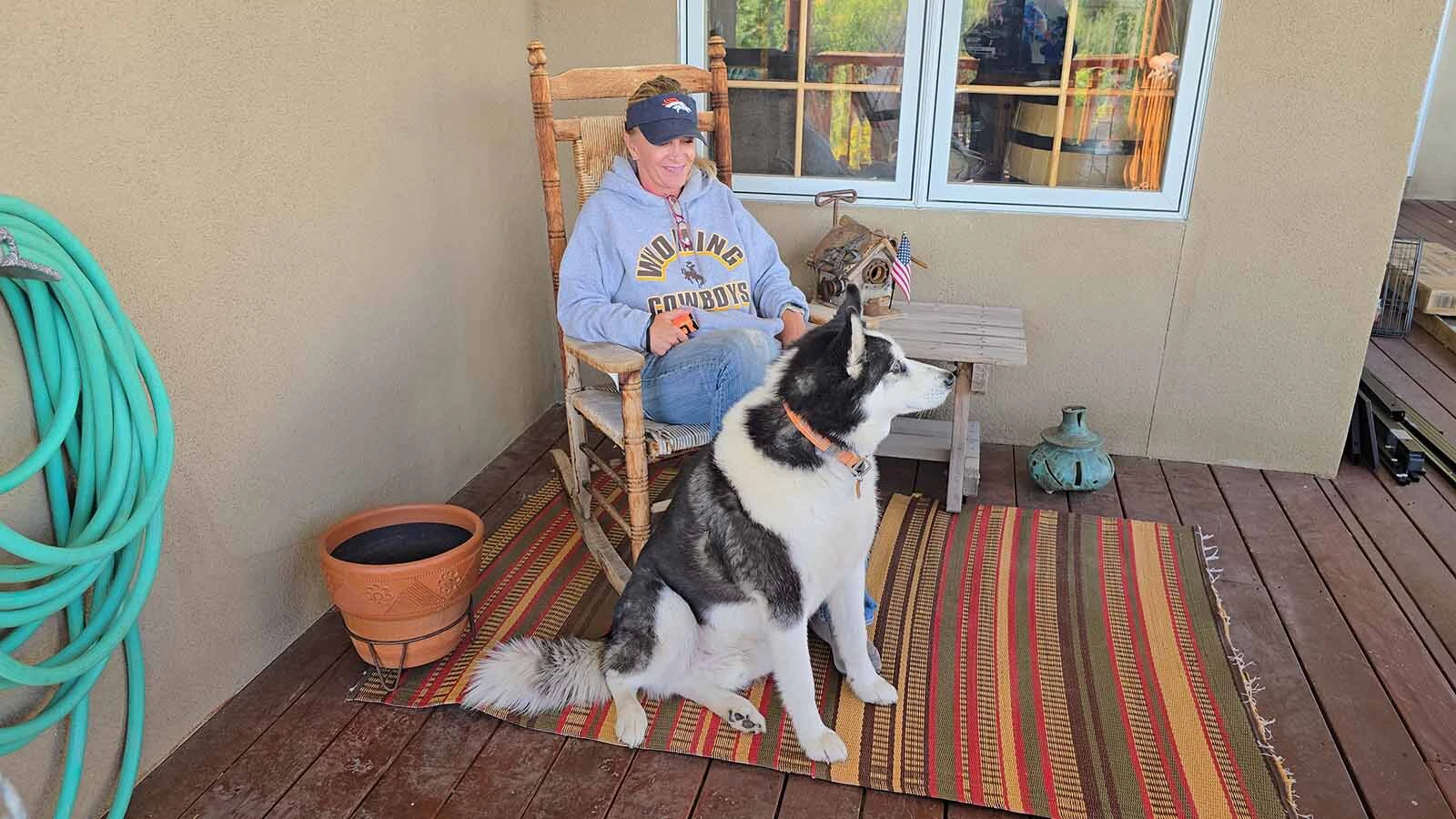 Alicia Brown sits in a rocking chair on her porch, looking at Sheep Mountain as she talks about why she moved to Centennial.