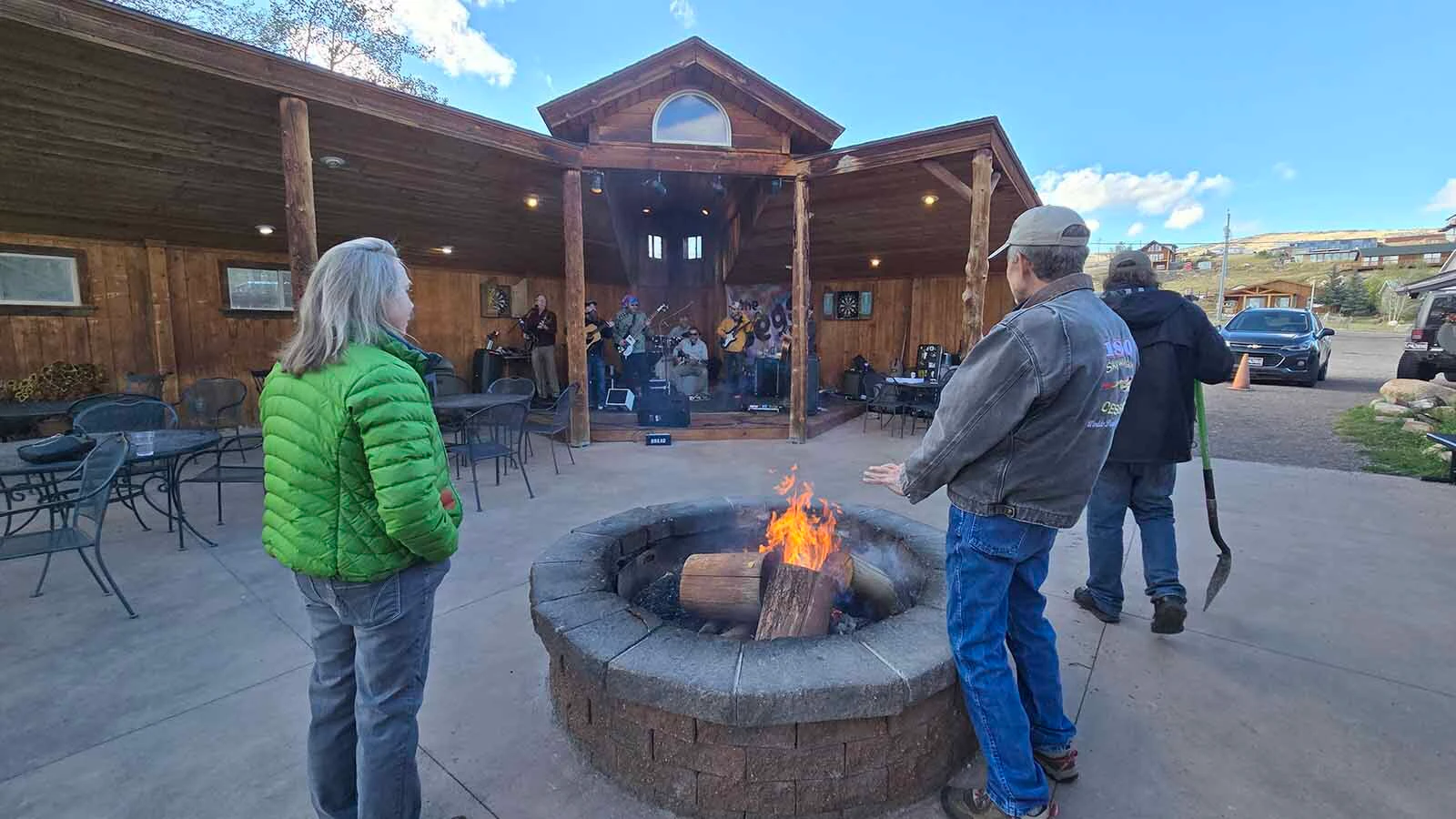 A small group of people gather to hear one of the season's last outdoor, live music concerts at Beat Bottom Grill.