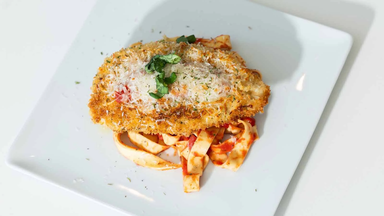 Chicken parmesan eaten with the setting sun in a mountain setting just tastes better chef Steve Ingber's clients tell him.