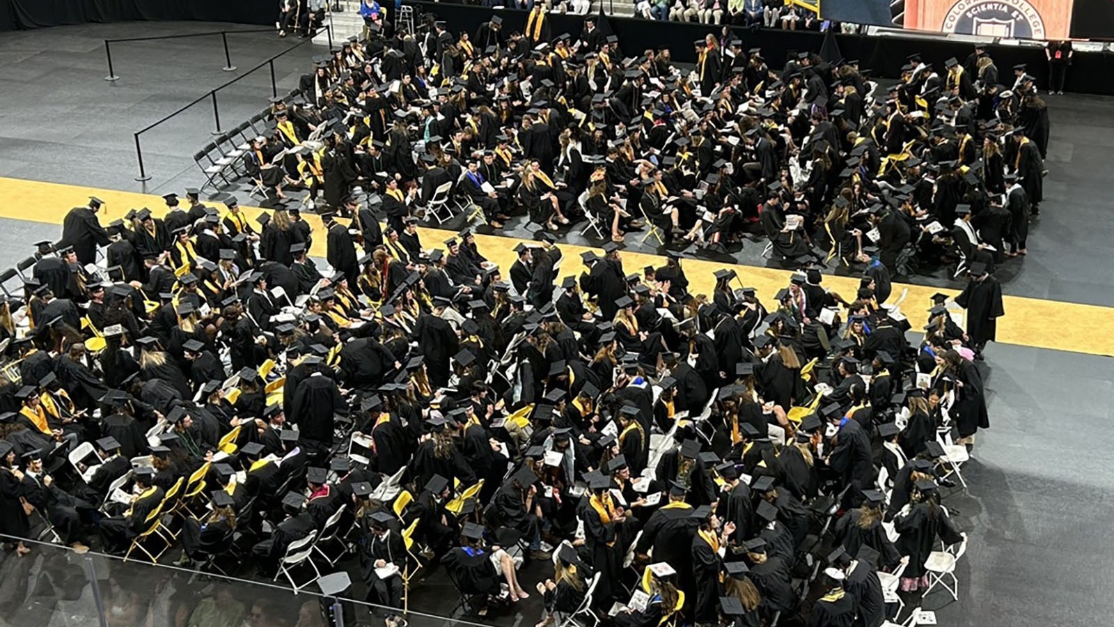 As Liz Cheney was introduced as the keynote speaker Sunday for the graduating class of Colorado College, some students turned their chairs to put their backs to her on stage, which is to the right out of frame.