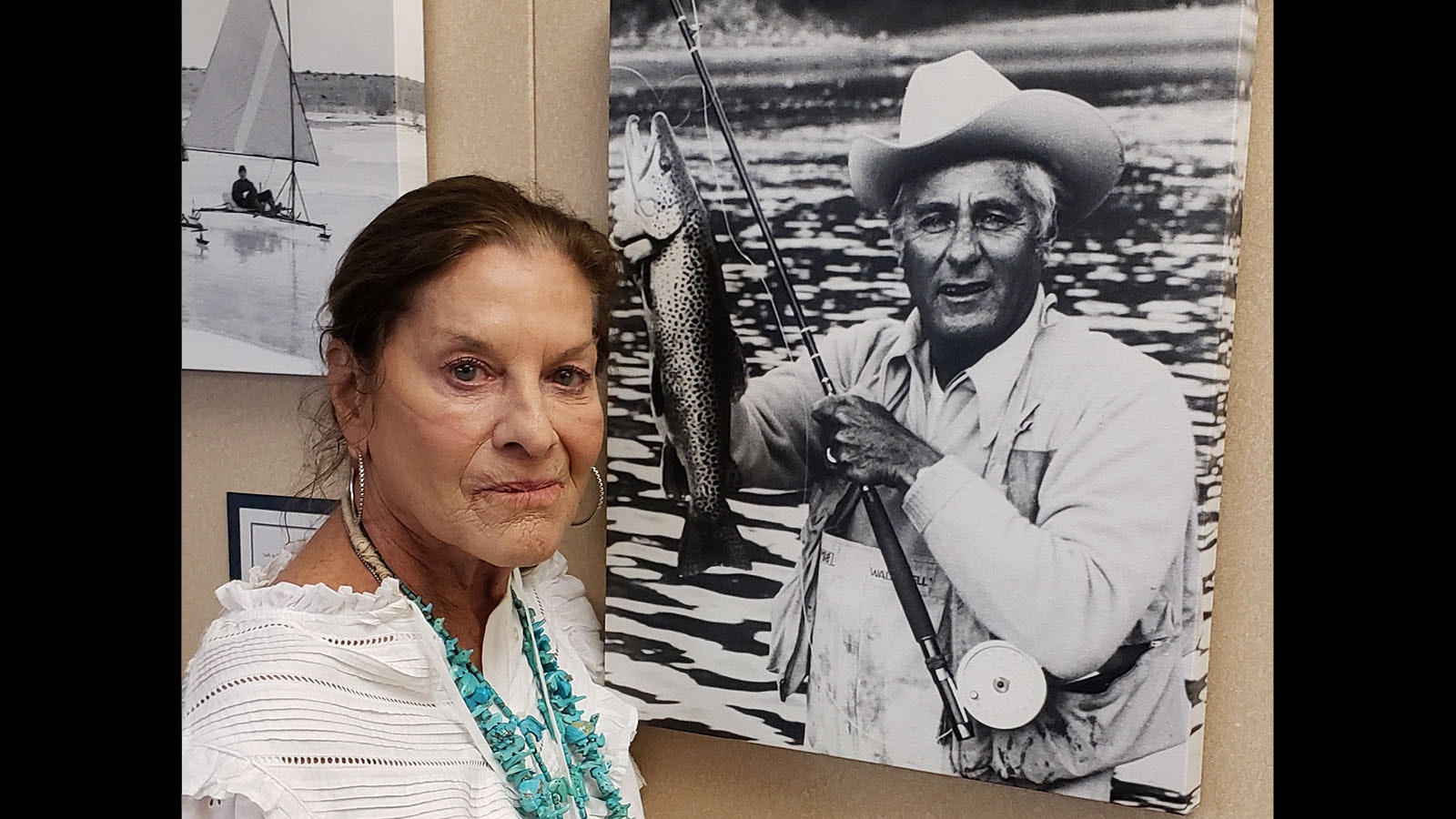 Cheryl Gowdy with a photograph of her famous father, Curt Gowdy.
