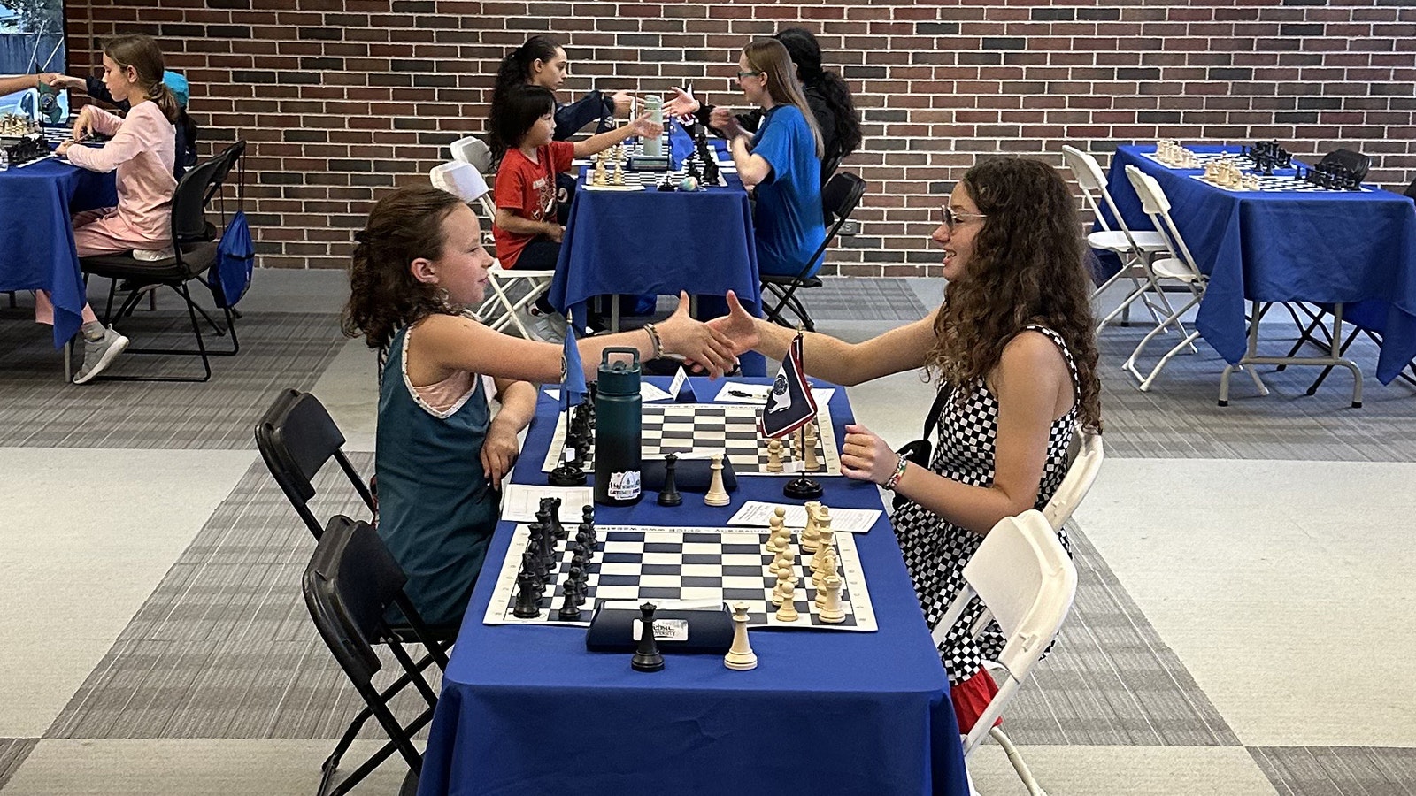 Kamari Barth, right, shakes hands with an opponent during the Susan Polgar Girls' Chess Tournament Invitational, held June 21-25. She's the first Wyoming girl to compete in the tournament.