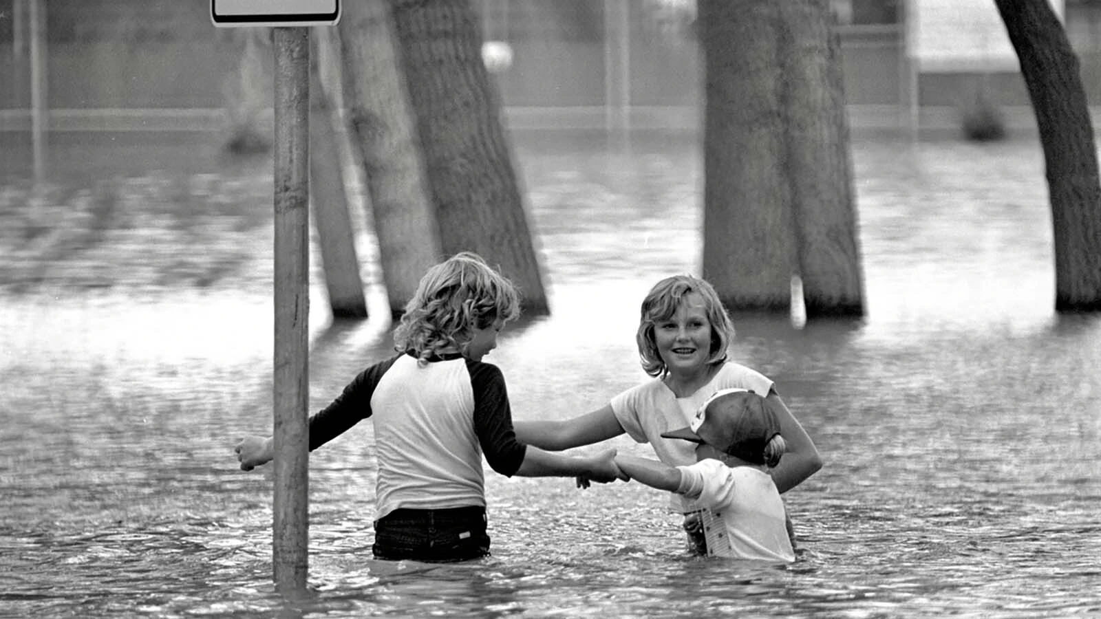 Children play in the floodwaters in downtown Cheyenne on Aug. 2, 1985, the day after more than half of the city’s annual rainfall fell in just a few hours.