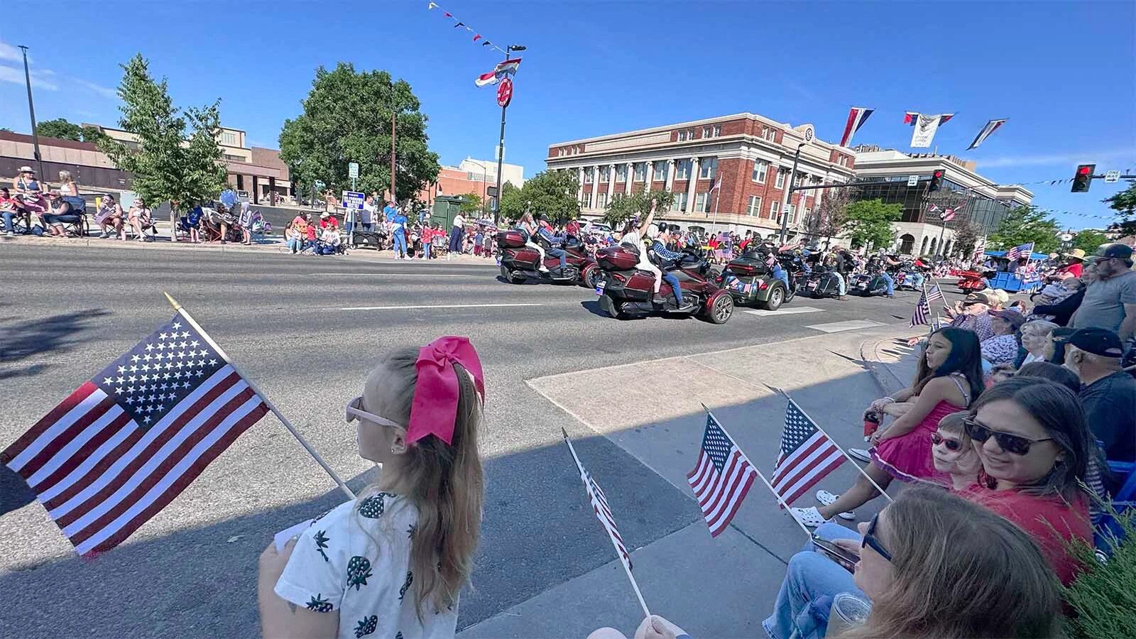 Rebekah Gunn waves an American flag as the Cheyenne 250th Fourth of July Parade makes its way north on Carey Avenue on Saturday. She turned 9 years old the day before, July 3.