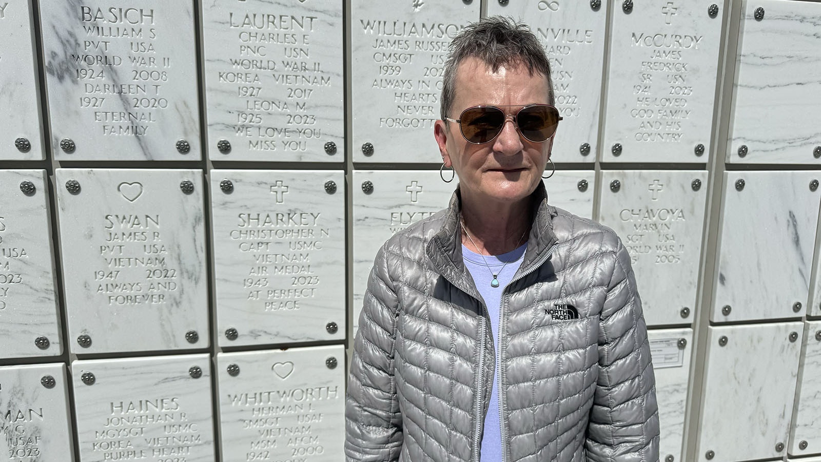 Jane Sharkey stopped by her husband’s marble nameplate on the columbarium to cry over her husband, “Crissy,” at the Cheyenne National Cemetery on Memorial Day.  He was a Marine who served in Vietnam, flew over 550 helicopter missions.