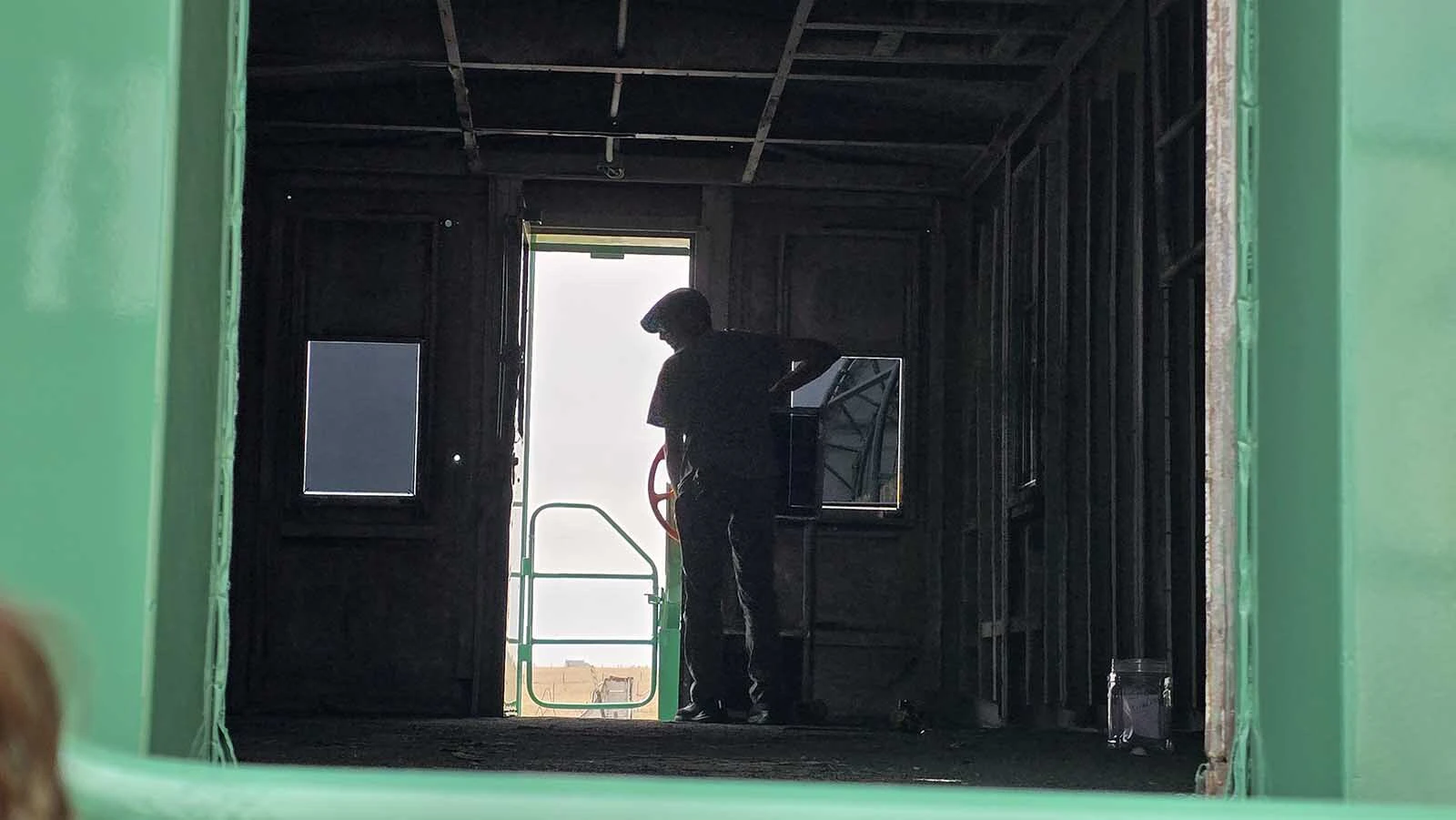 A worker places the last window into a caboose that's being restored for Cheyenne's 15th Street Railcar experience.