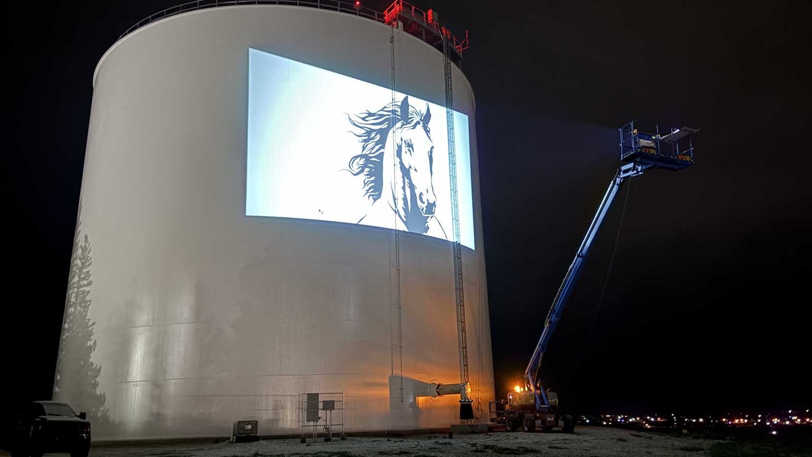 Cheyenne artist Jordan Dean is painting two giant 60-to-70-foot horses as the centerpiece of a stunning mural on a prominent water tank. It takes two giant booms, a projector and $400 a gallon paint.