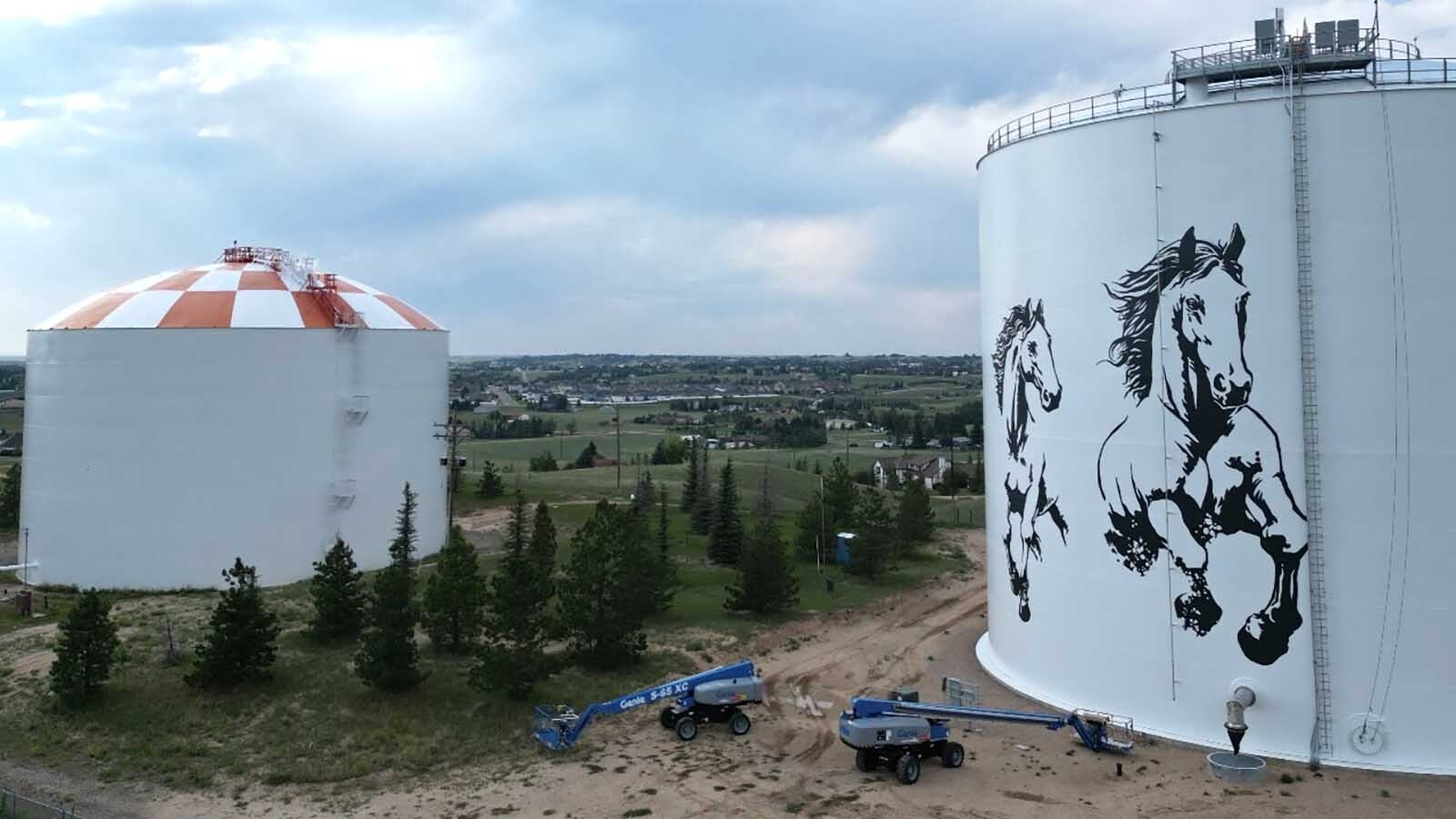 Cheyenne artist Jordan Dean is painting two giant 60-to-70-foot horses as the centerpiece of a stunning mural on a prominent water tank. It takes two giant booms, a projector and $400 a gallon paint.