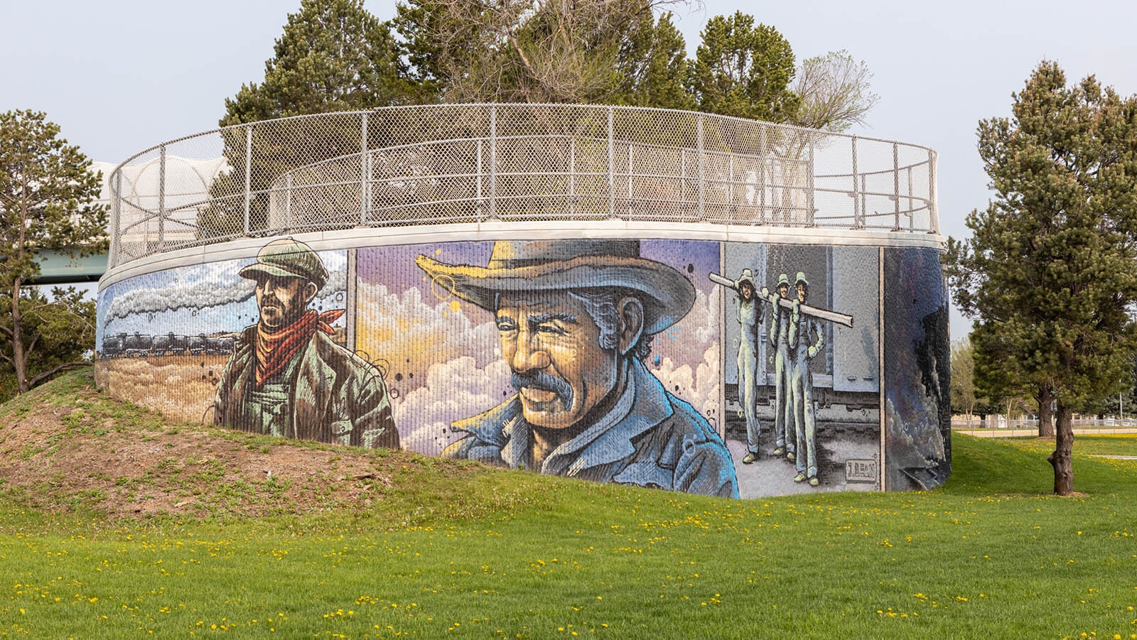 This gallery of photos shows a large, sweeping mural on the pedestrian overpass on West 7th Street and Central Avenue in Cheyenne. It was painted by Jordan Dean.