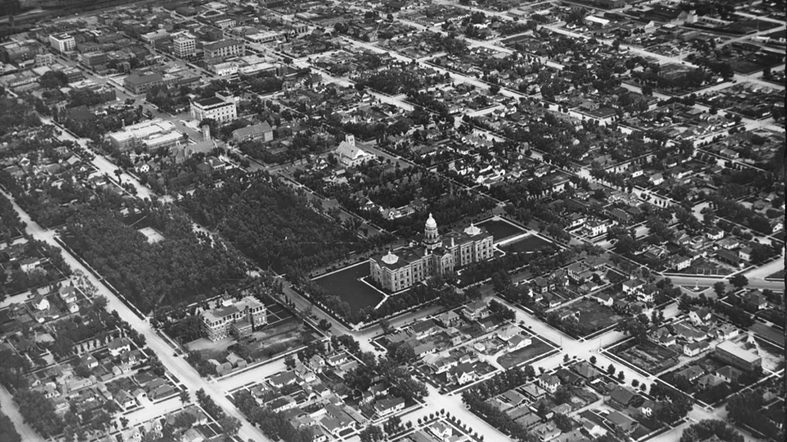 By 1930, Cheyenne had filled its neighborhoods with trees, as seen in this aerial photo looking down on the Wyoming Capitol.