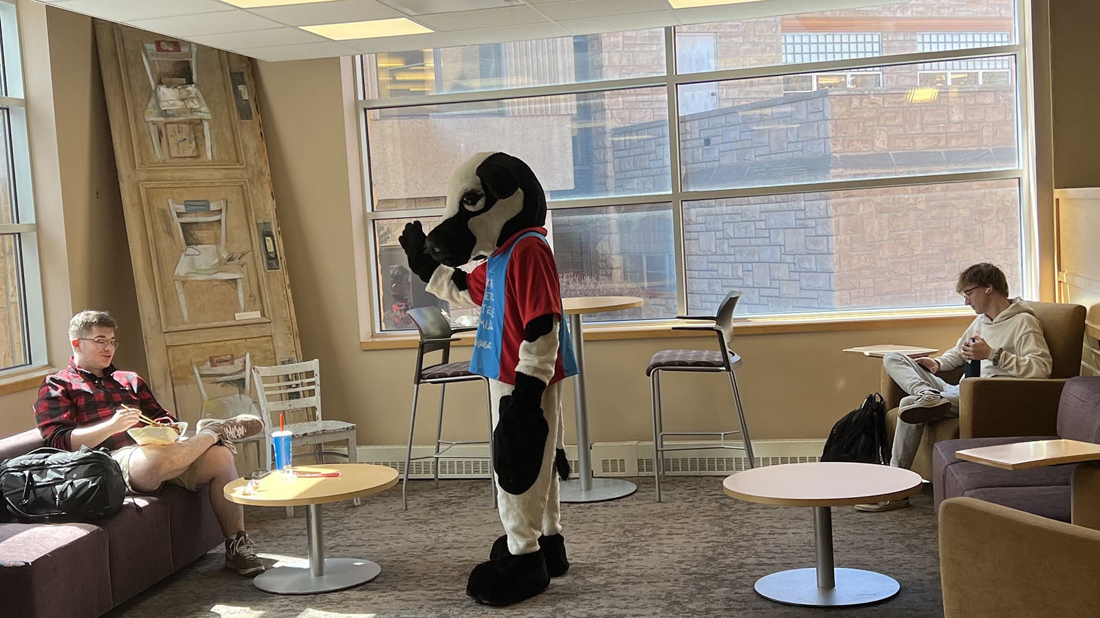 The Chick-Fil-A cow mascot chides someone for eating Panda Express instead of Chick-Fil-A in the University of Wyoming Union on Thursday.