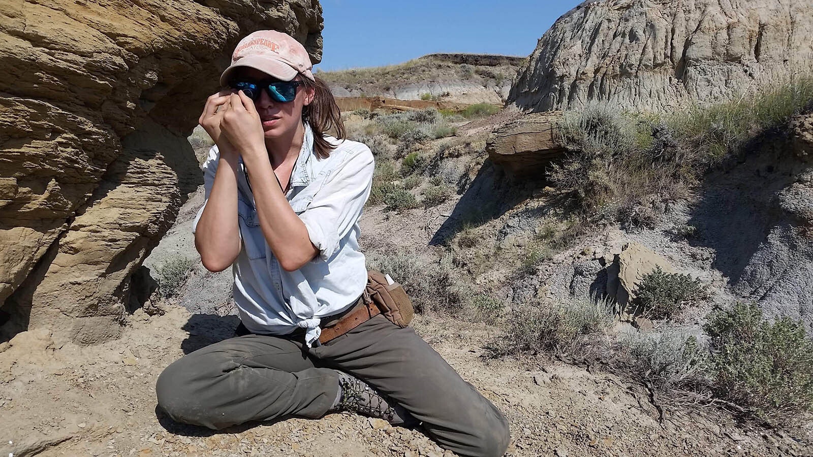 Jade Simon examining fossil eggshell in the field.
