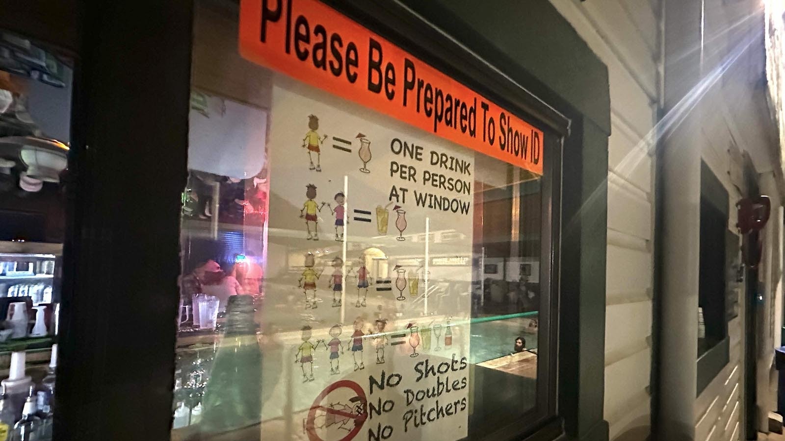 Bartender Rachel Moan accepts dry dollar bills from customers inside and soggy dollars from hot springs customers, who are warned — don’t drink too much, and don’t pee in the pool.