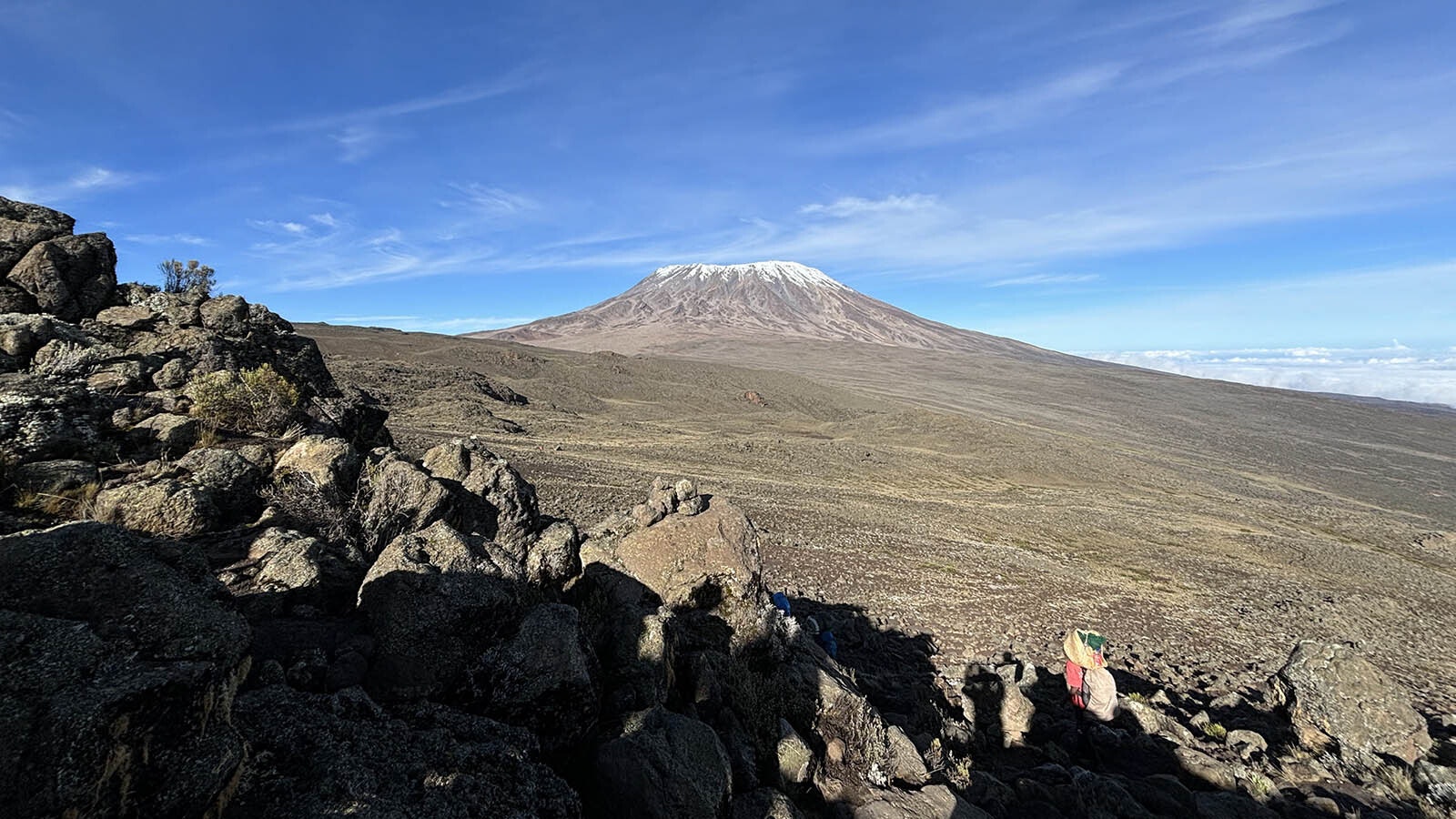 Mount Kilimanjaro's peak looms in the distance.
