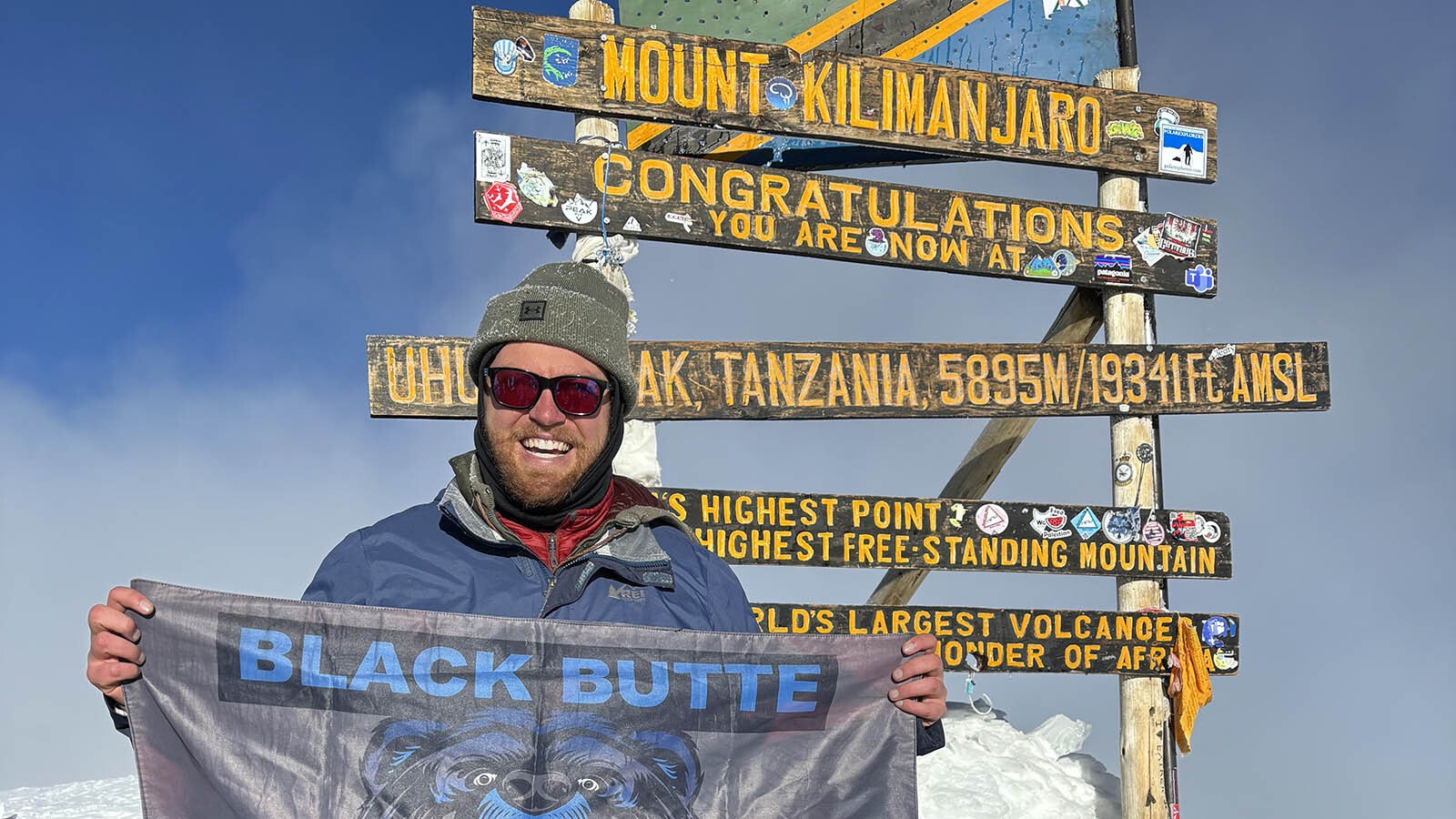 Rock Springs Spanish teacher Chris Clifton shows a Black Butte High School flag at the top of Mount Kilimanjaro.