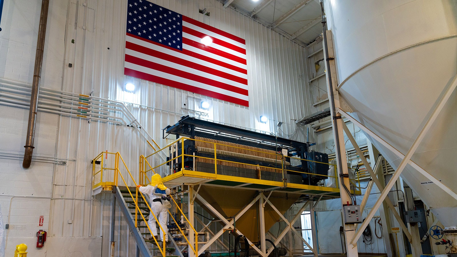 A worker climbs the stairs at a filter press at the Irigaray central processing plant.