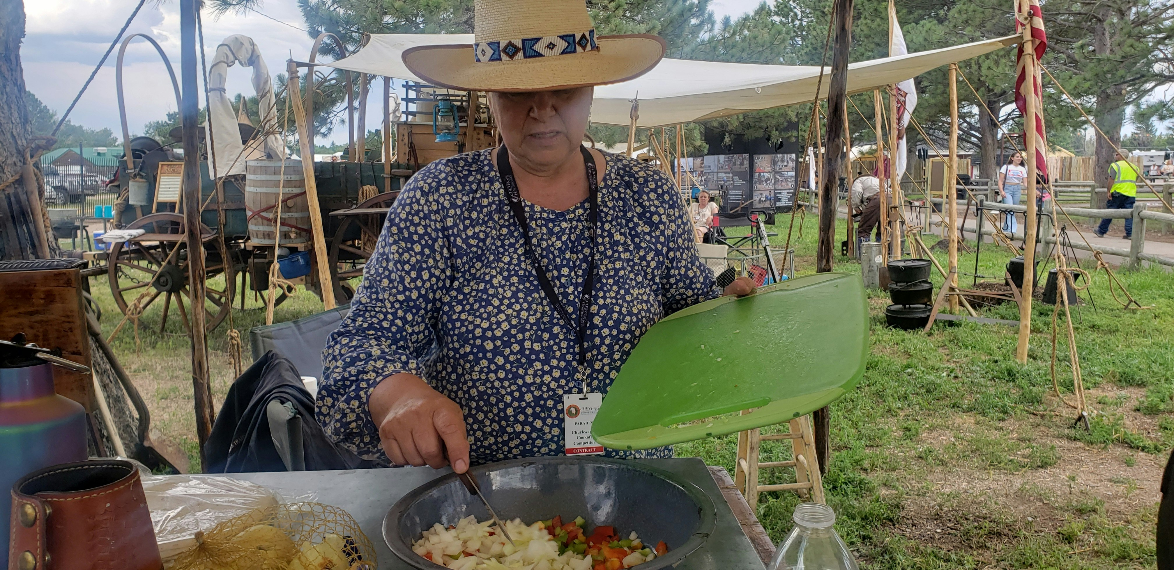Deb Herman finishes slicing up vegetables for a private taco and fajita night at the chuckwagon camp.