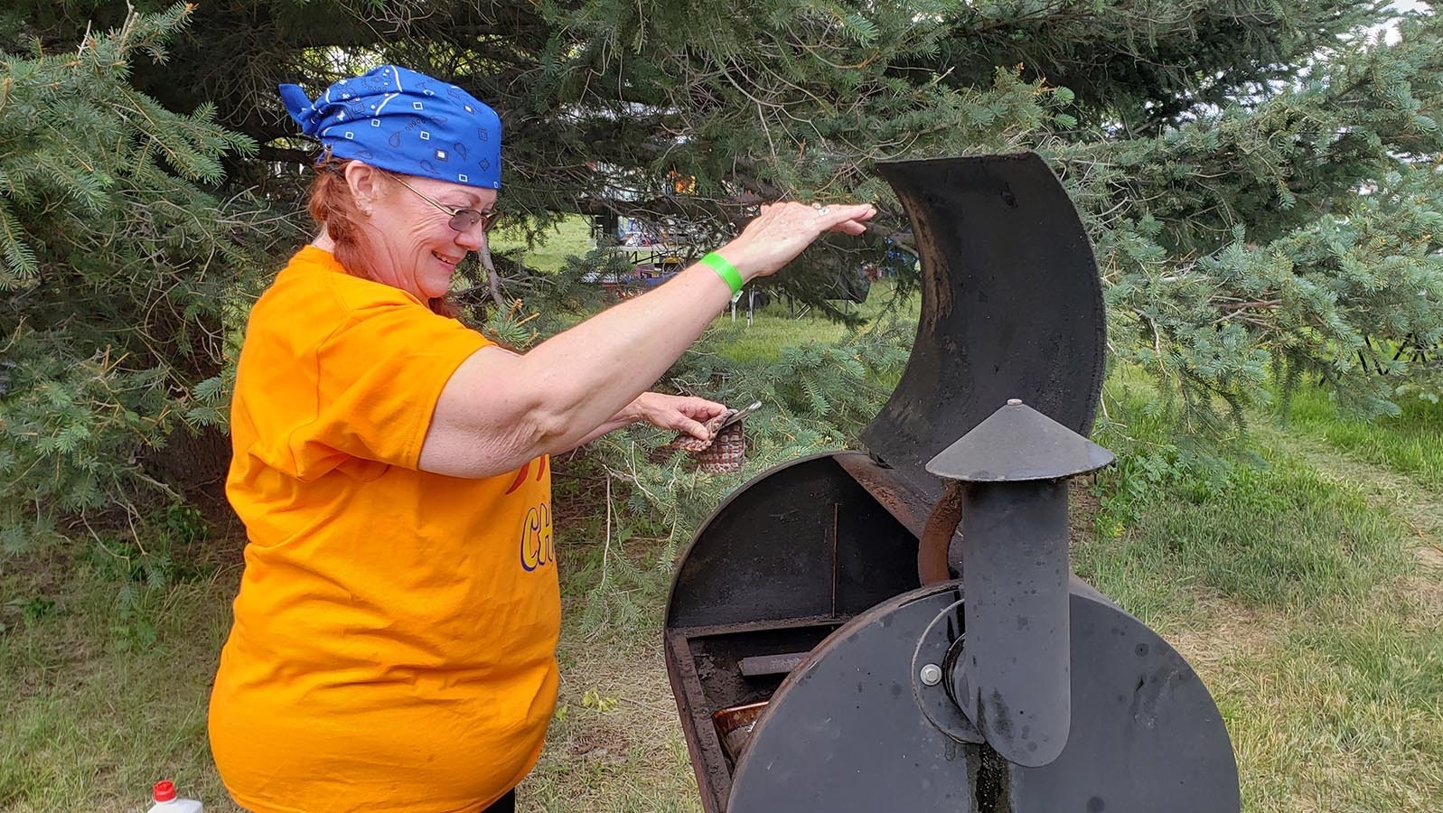 A competitor prepares her smoker for the cookoff.