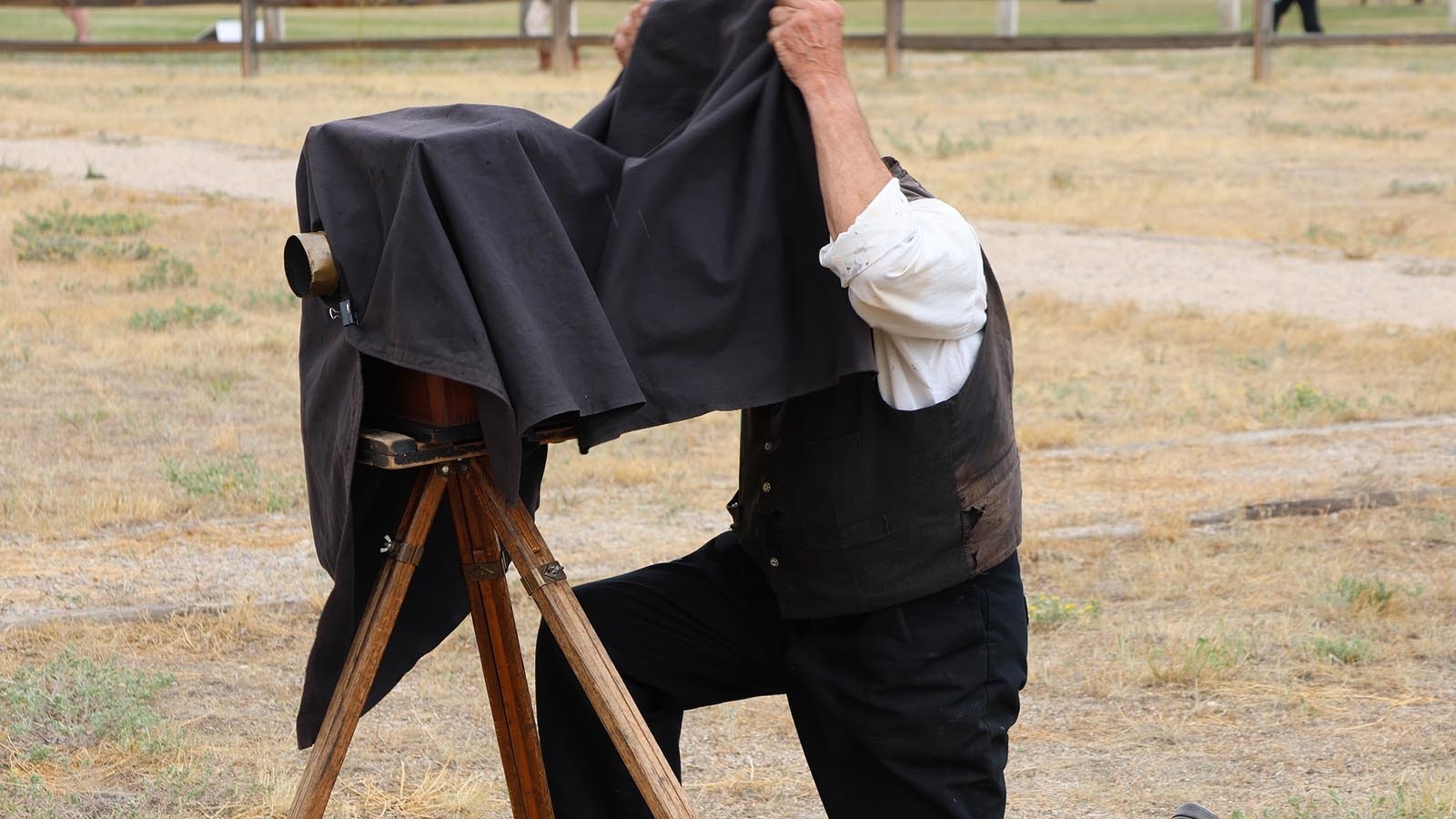 Photographer Robert Szabo frames and focuses the camera on a group of reenactors at Caspar Collins Day at Fort Caspar.