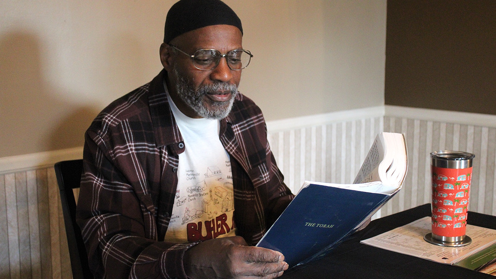 Clarence Fisher reads the Torah at a local Cheyenne coffee shop. He said finding God saved his soul and changed his perspective on life. After 32 years in prison, he's now living his best second life.