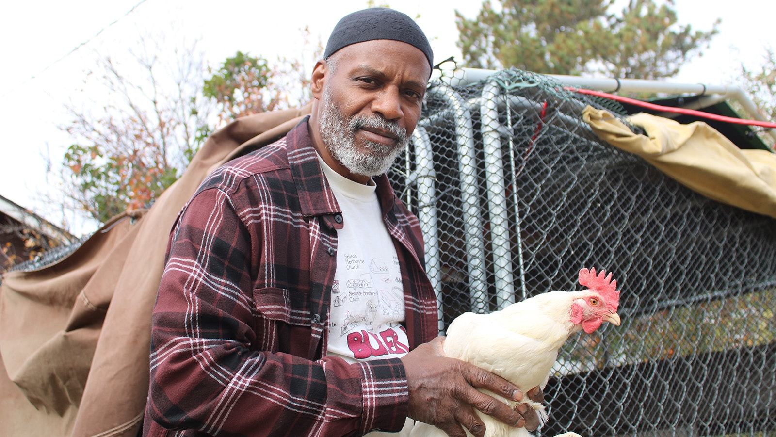 Clarence Fisher with one of his chickens.