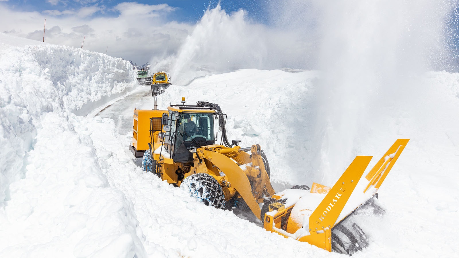 Crews in Yellowstone National Park work Thursday to clear parts of the Beartooth Highway, which still has up to 6 feet of wet, heavy snow on it.
