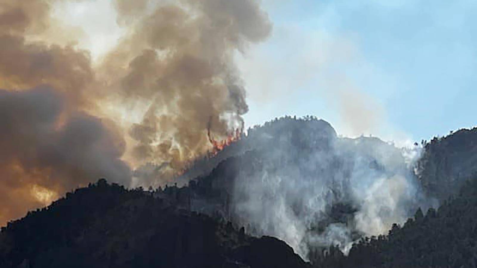 The Clearwater fire continues to burn in the rugged terrain of the Shoshoni Naitonal Forest near the East Entrance to Yellowstone.