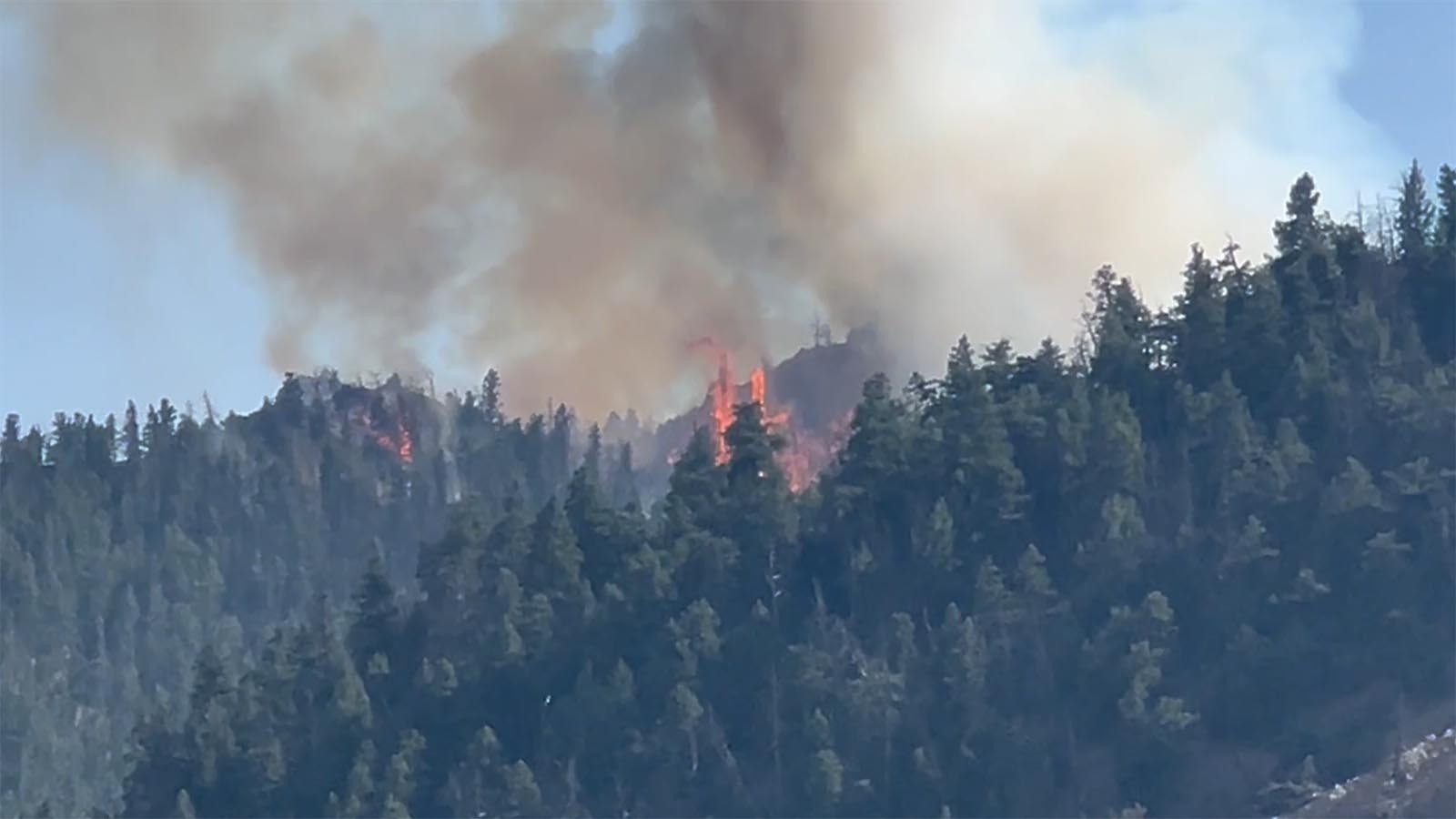 The Clearwater fire continues to burn in the rugged terrain of the Shoshoni Naitonal Forest near the East Entrance to Yellowstone.