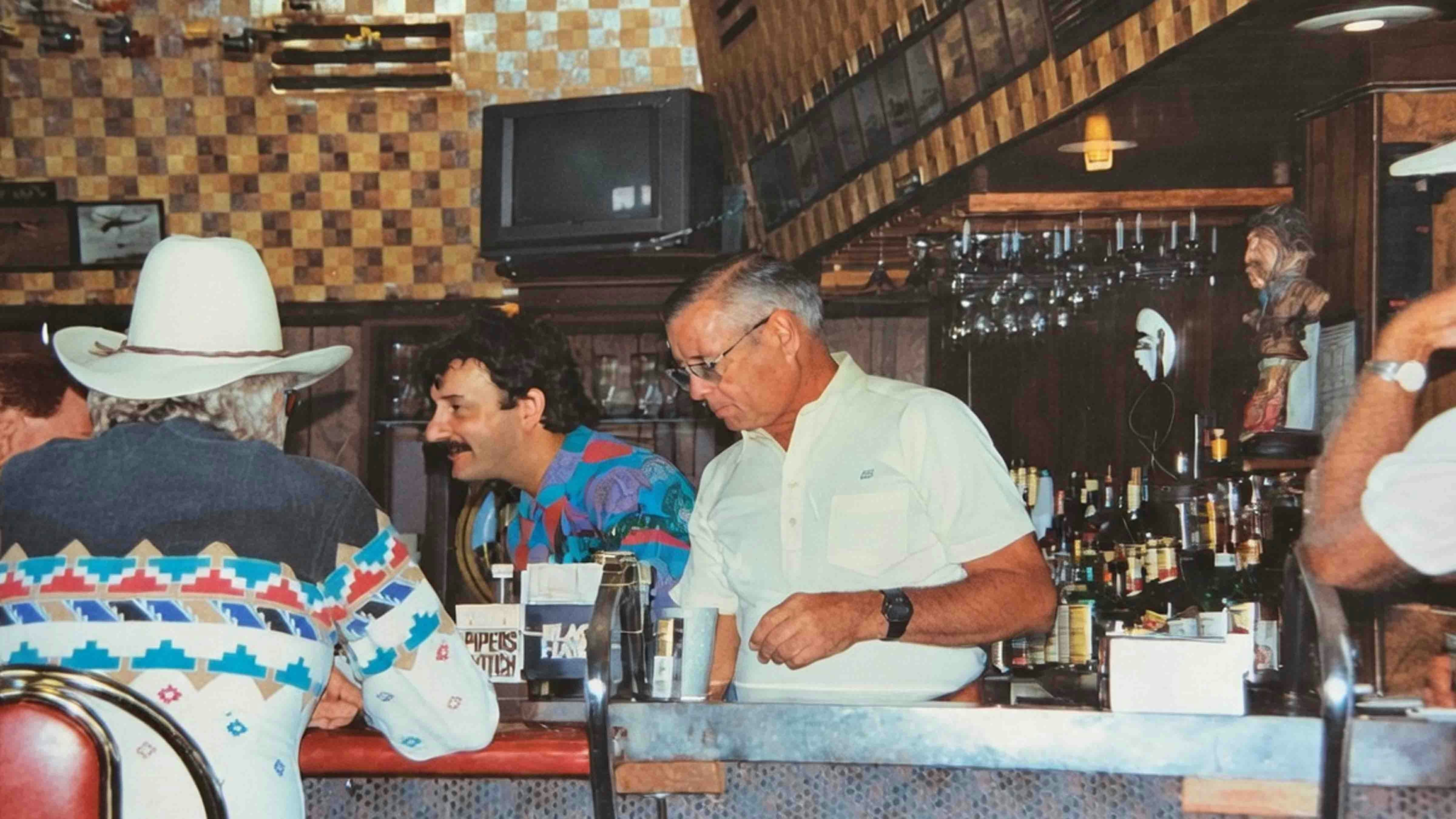 “A view of the Cloud 9 bar at Happy Hour.”  The bartenders are Rich Magor (white shirt) and Gus Anastapoulos