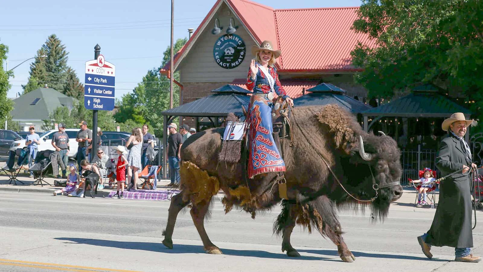 Miss Rodeo America, Olivia Favero, leading the 2026 Cody Stampede Parade from the back of Clyde the Buffalo.