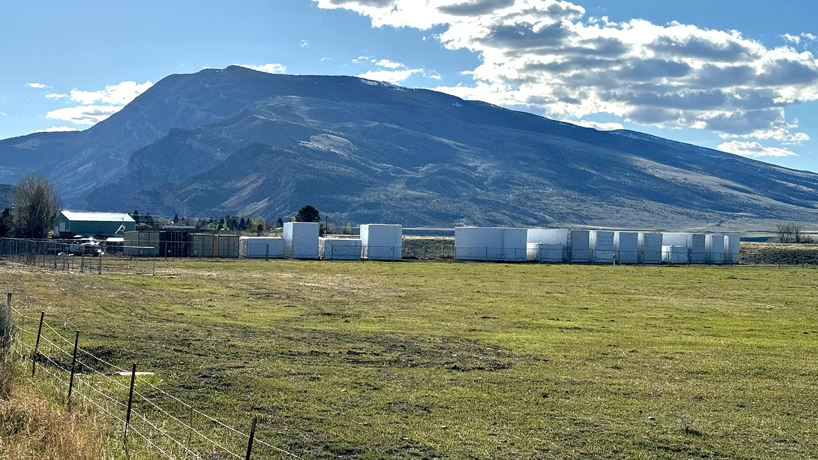 An array of large shipping containers holding materials to build a proposed Church of Jesus Christ of Latter-day Saints temple in Cody are staged at the site.