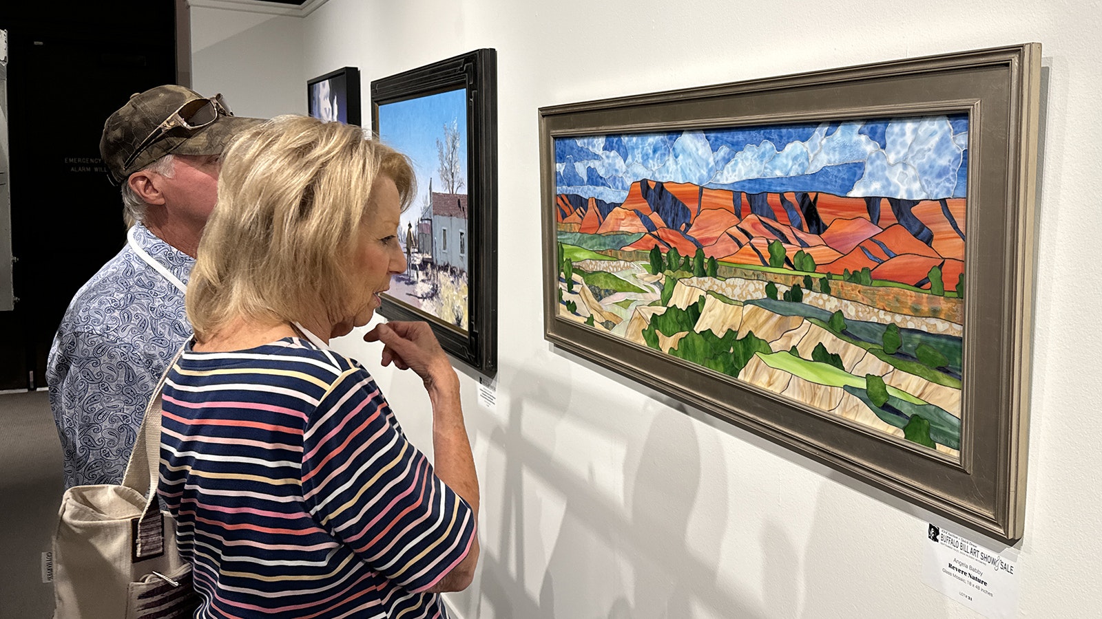 Cody resident Sally Ogletree admires "Revere Nature," a glass mosaic by Angela Babby. The 43rd Annual Buffalo Bill Art Show and Sale includes 104 pieces from 104 contemporary Western artists, which will be on display until the live auction on Sept. 20.