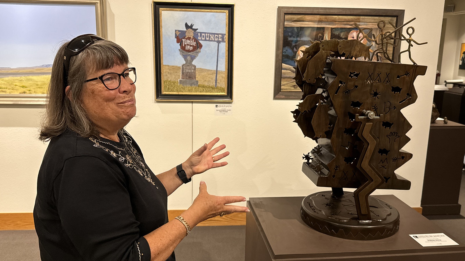 A spectator admires "Buffalo Jump," a kinetic steel sculpture by Charles Ringer, in the gallery of the 43rd Buffalo Bill Art Show and Sale.