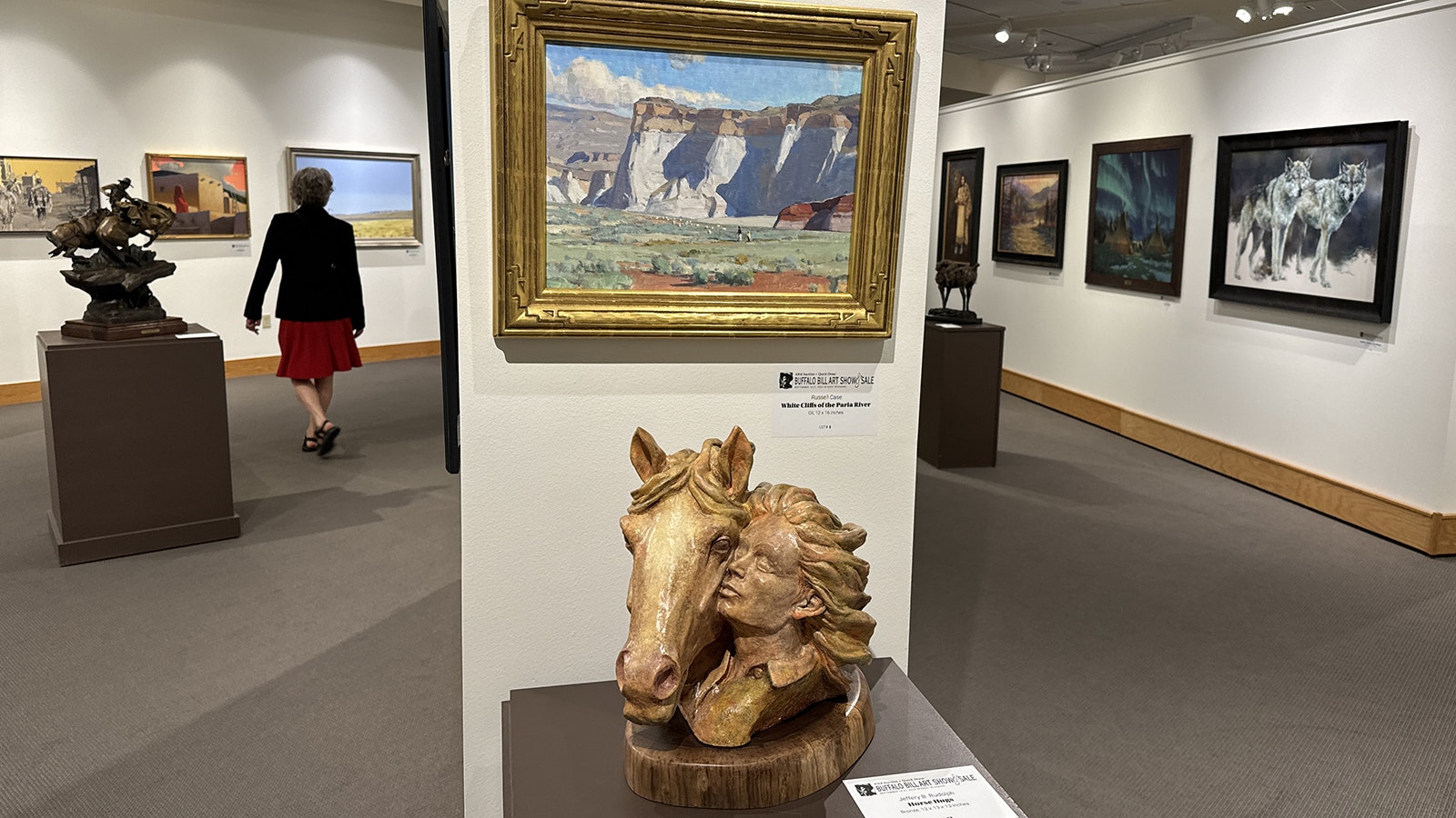 Jeffrey Rudolph's ceramic "Horse Hugs" sits beneath Russell Case's oil painting "White Cliffs of the Paria River" at the 43rd Buffalo Bill Art Show and Sale at the Buffalo Bill Center of the West in Cody.