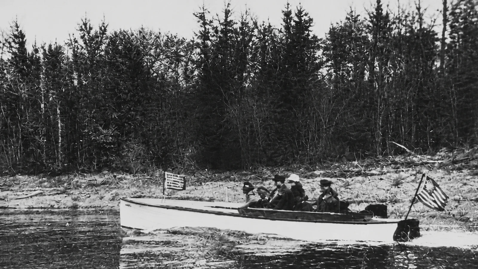 Grosvenor "Doc" Barry ran the Cedarvale Dude Ranch in the Bighorn Canyon from about 1913 to 1930. He would begin each 'dude's' adventure with a two-hour trip over rapids in his homemade wooden powerboats. He is pictured here with several companions on the Bighorn River. 