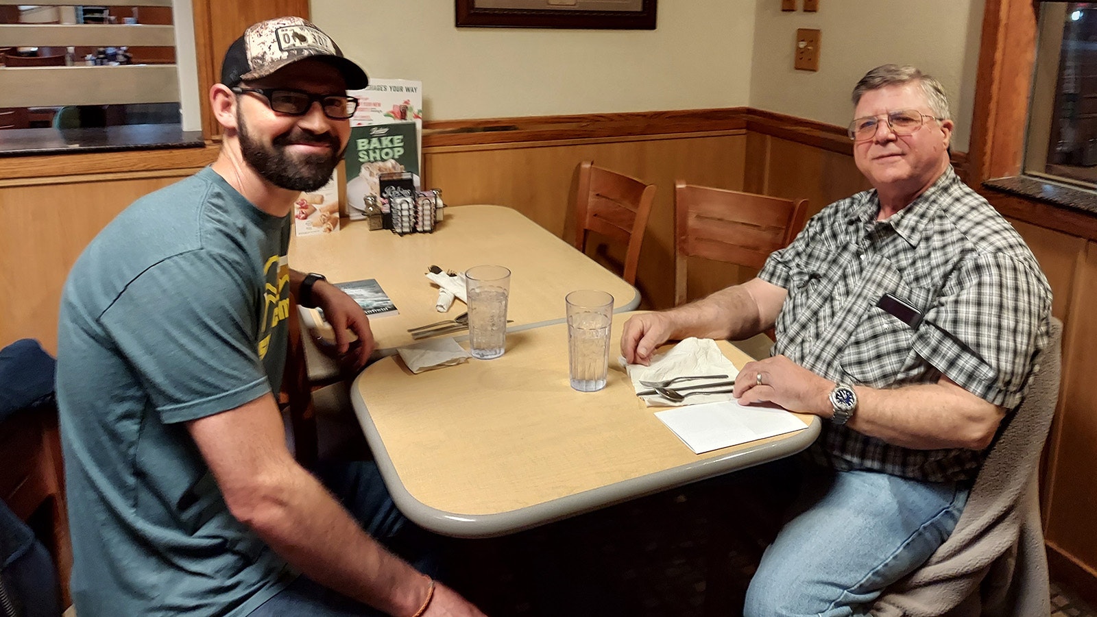 Tim Schofield and pastor of the Redemption Church, Josh Yelton, take a break from Bible study Friday morning to talk politics. They meet at Perkins in Gillette.