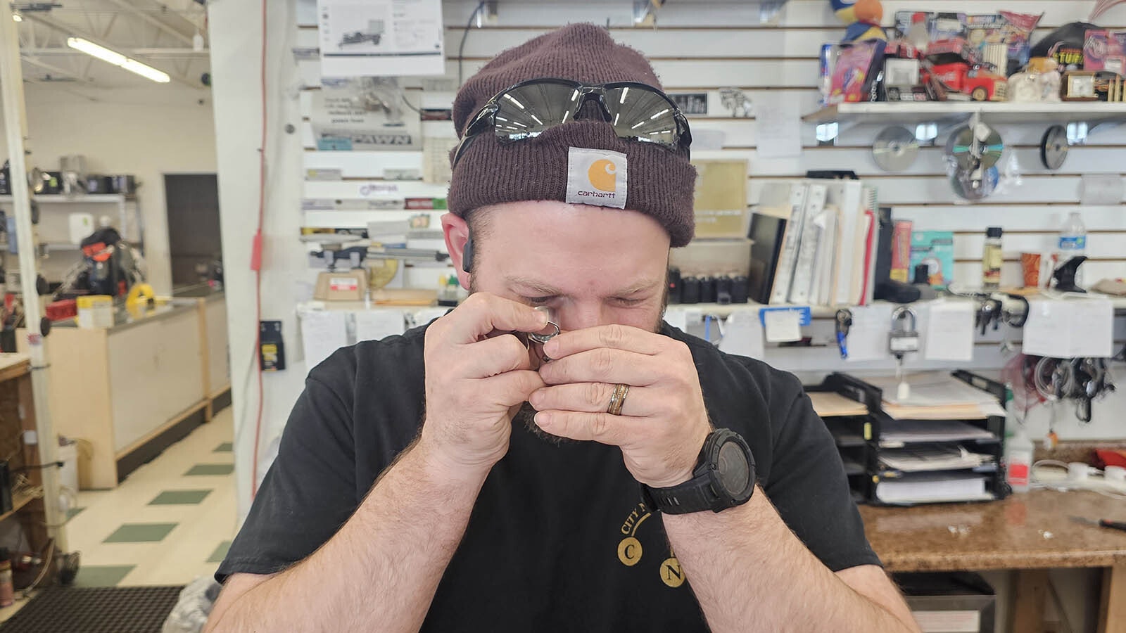 City National Pawn's coin master Joe Bohlinger looks at the tail feathers of a 2000-P Sacagawea coin, to see if it is a "Cheerios" coin. It wasn't, but if it had been, it would have been worth around $6,600 if in mint condition.