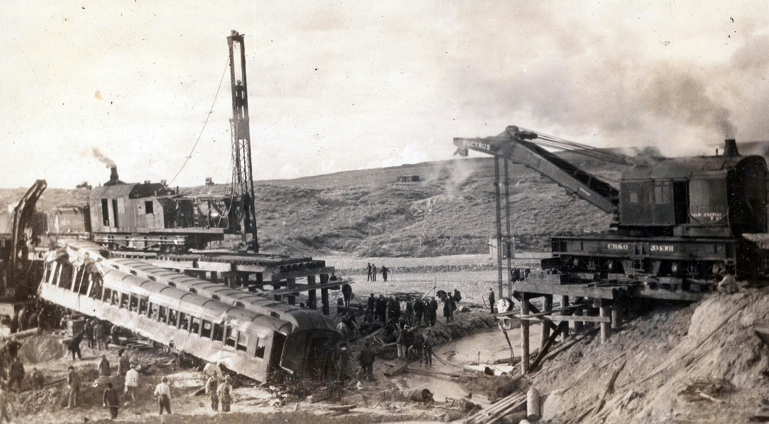 Crews work to recover the wrecked train that plunged into Cole Creek in 1923, killing dozens.