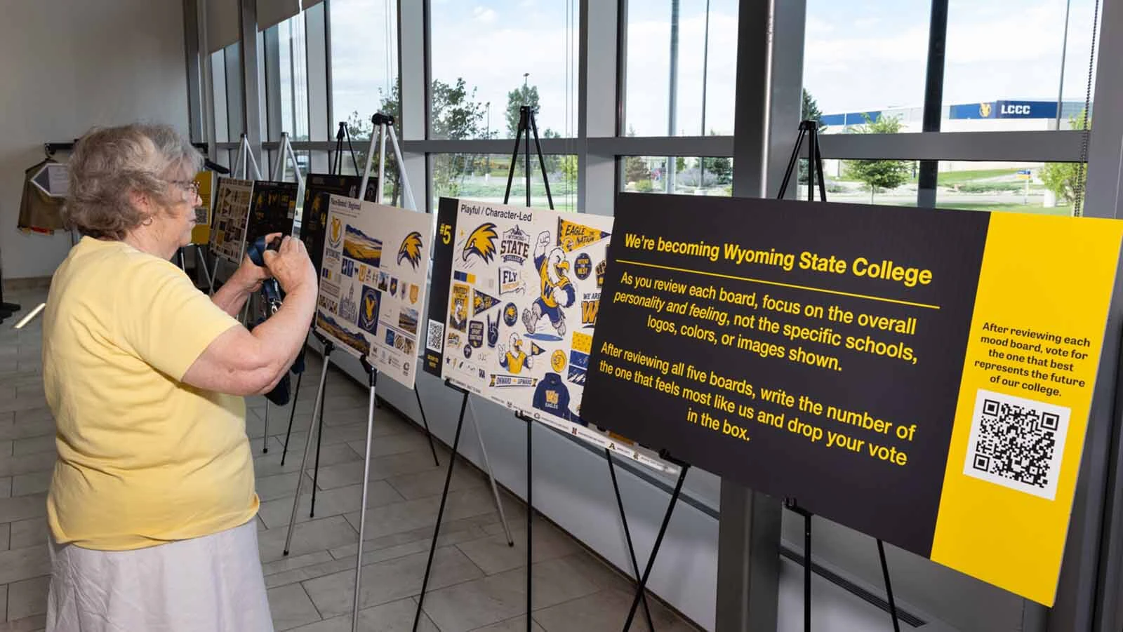 Guests view new design options for the rebranded Wyoming State College on Monday, Aug. 17, 2026, at LCCC in Cheyenne.