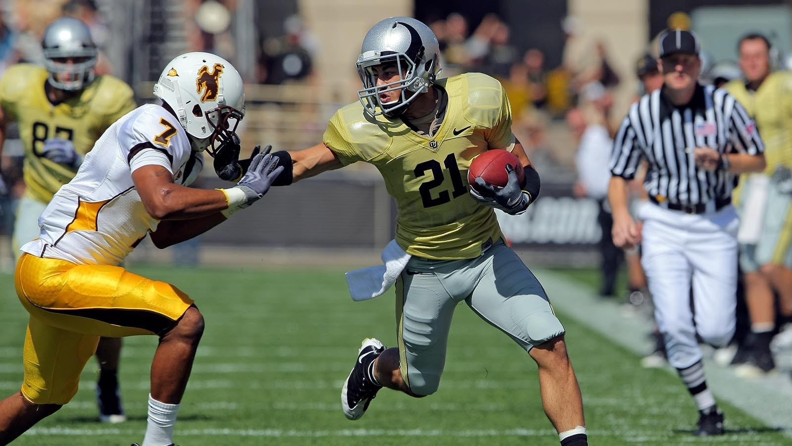 Wide receiver Scotty McKnight of the Colorado Buffaloes makes a reception for a first down before being forced out of bounds by Shamiel Gary of the Wyoming Cowboys at Folsom Field on Sept. 19, 2009, in Boulder, Colorado. CU was wearing an alternative uniform in the game.