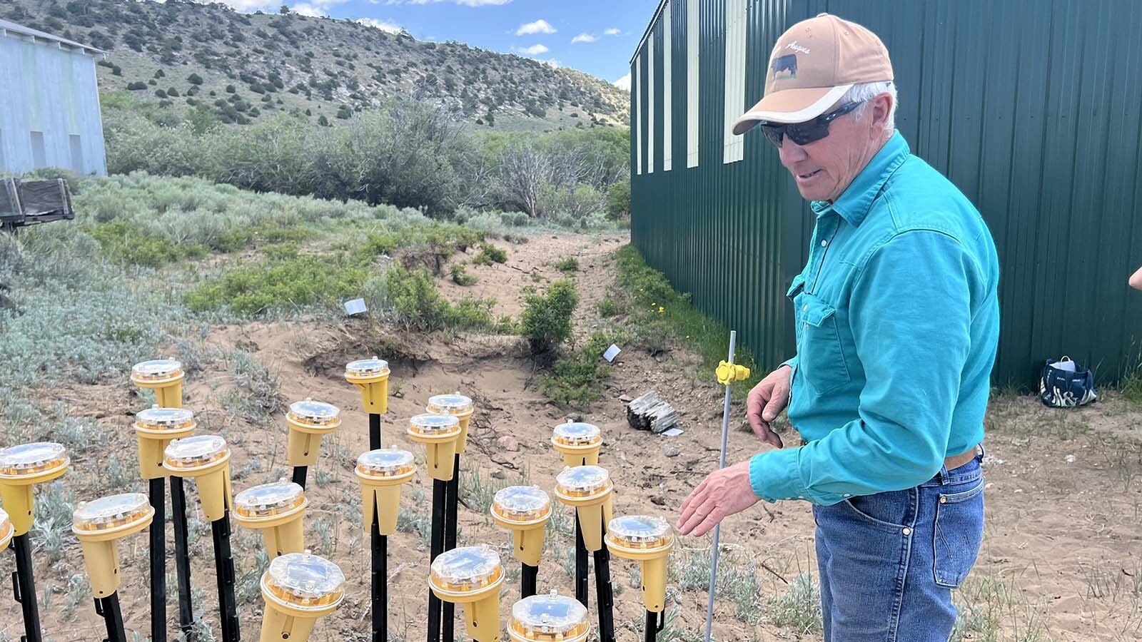 Northern Colorado rancher Don Gittleson explains “Fox Lights,” or solar-powered, multi-colored flashing lights, intended to deter wolves from attacking cattle on his ranch near the Wyoming state line.