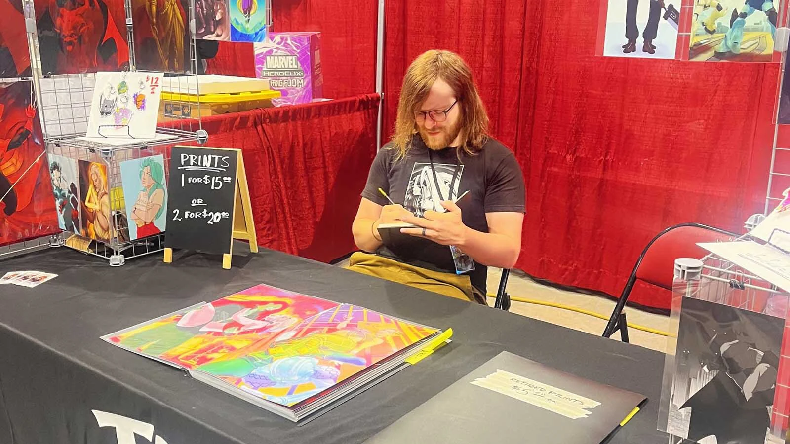 Artist Robert Tweedy works behind his booth during a Comic Con. "It's a great sense of community," Tweedy says of Wyoming's growing pop culture conventions.