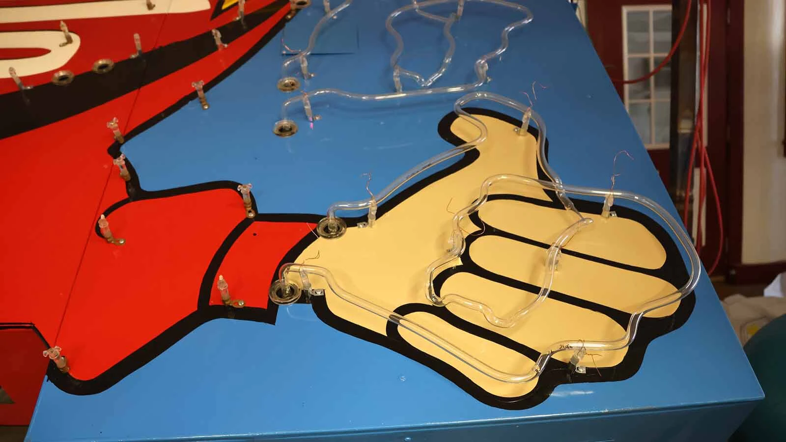 Connie Morgan’s working with the cowboy’s hand to figure out neon needs.