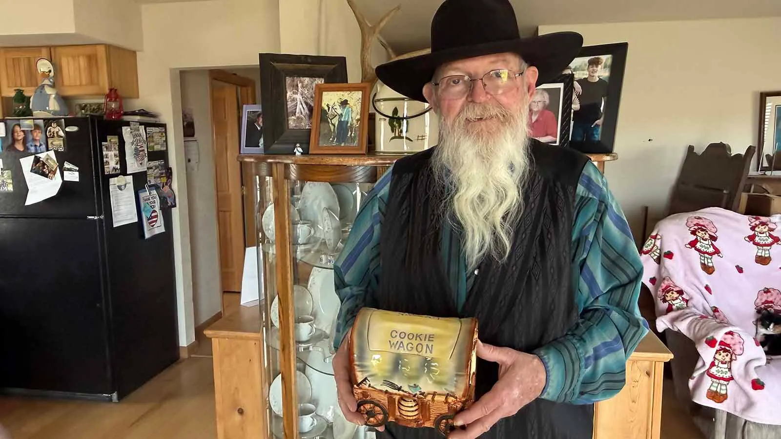 Cookie jars are a common decoration in most kitchens in Thermopolis, Wyoming because of the popularity of the Cookie Jar Auctions in the small community. Each year, tens of thousands of dollars are raised to help pay the medical bills of the residents most in need. John Gerrells, who first proposed the idea over 30 years ago, has boxes full of cookie jars ready for the next auction and has kept a few of his favorites as keepsakes. His sheep wagon cookie jar has become a running joke between him and a friend who take turns bringing it to the auctions and bidding on it.
