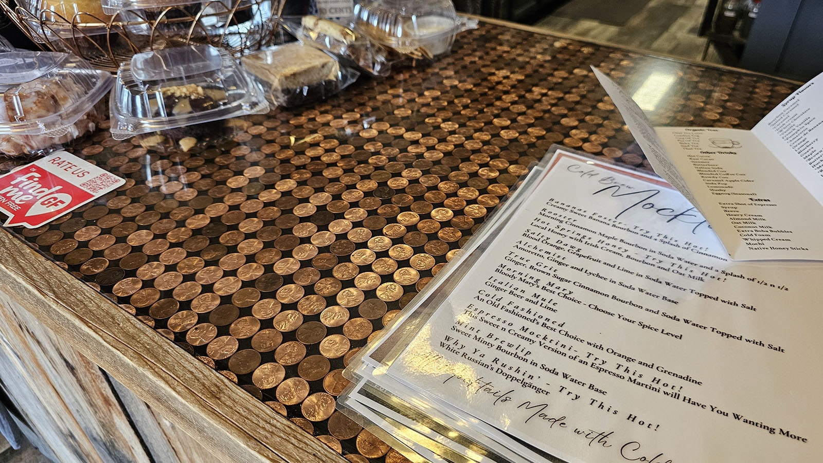 The counter has been inlaid with pennies, each one individually glued down. There are more than 5,000 pennies.