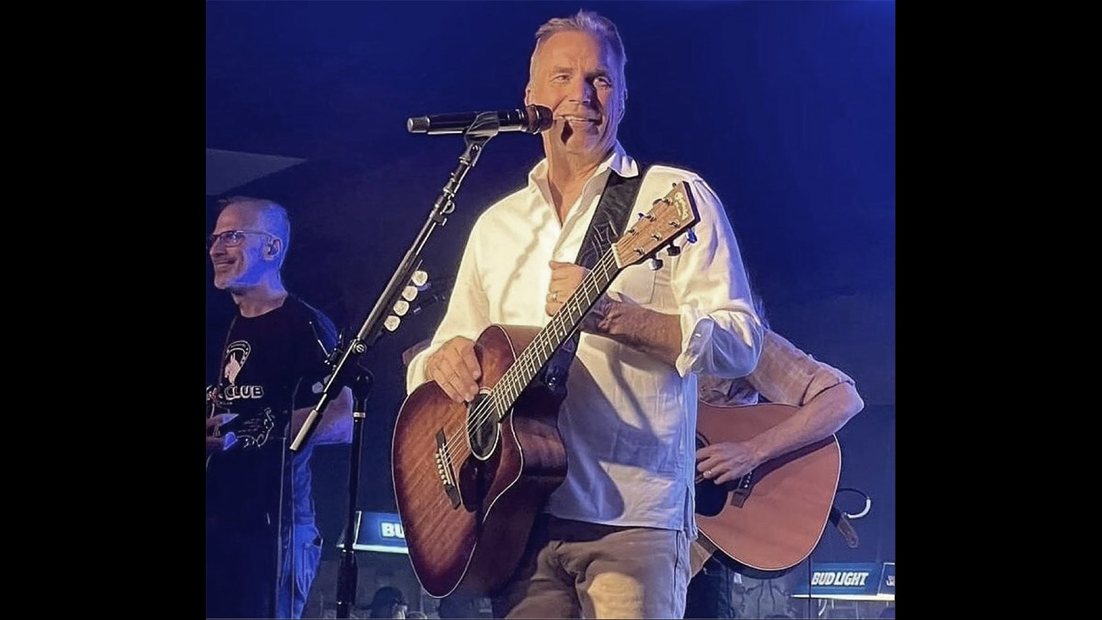 Costner on stage with his band Modern West in 2021.