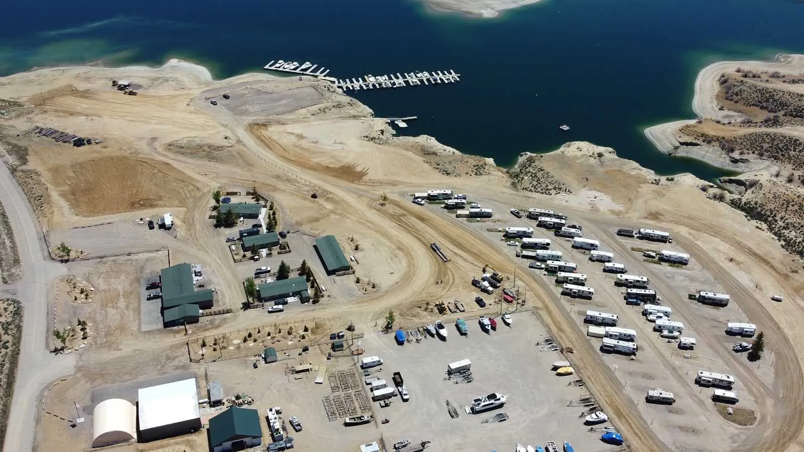 Releases of up to 1 million acre-feet of water downriver from Flaming Gorge are gutting the gorge’s world-famous kokanee fishery and has marinas racing to survive. “This is like a holocaust for nature,” said one marina owner about the impact. Above, Buckboard Marina before last year's season. The water level is dramatically lower now, and getting lower.