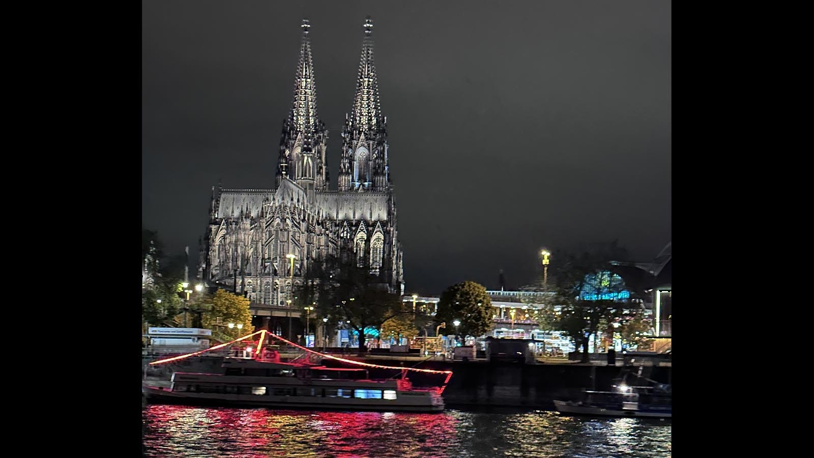 A view of the Cologne Cathedral at night from the Rhine River.