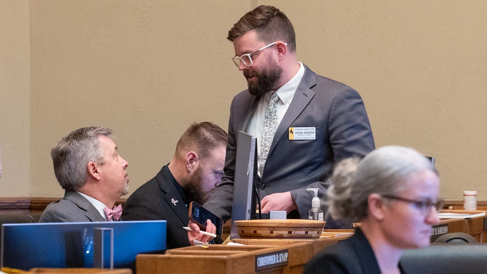 State Rep. Ocean Andrew, R-Laramie, standing, talks with Rep. Ken Clouston, R-Gillette, on the House floor Wednesday.